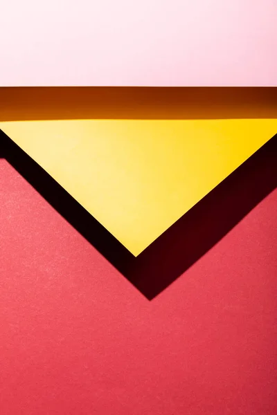 Top view of empty pink and yellow paper sheets on crimson — Stock Photo