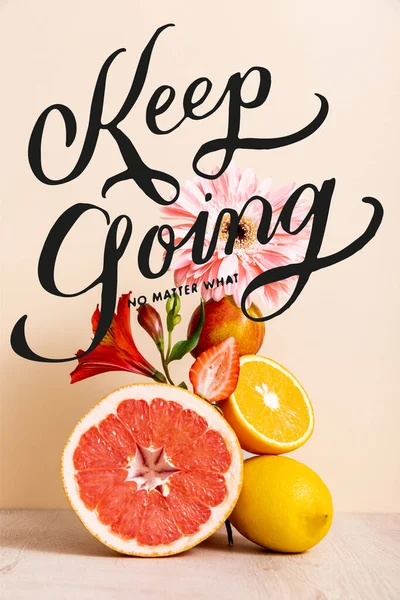 Floral and fruit composition with citrus fruits, strawberry and peach near keep going no matter what lettering on beige — Stock Photo