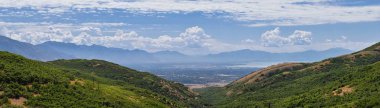 Panoramic Landscape view from Travers Mountain of Provo, Utah County, Utah Lake and Wasatch Front Rocky Mountains, and Cloudscape. Utah, USA. clipart