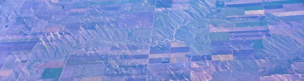 Aerial view of crop circles and squares over midwest states on flight over Colorado, Kansas, Missouri, Illinois, Indiana, Ohio and West Virginia during autumn. Grand sweeping views of agriculture landscape. Views of crops, rivers, plains, mountain an