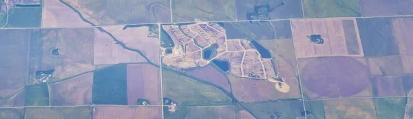 Aerial view of crop circles and squares over midwest states on flight over Colorado, Kansas, Missouri, Illinois, Indiana, Ohio and West Virginia during autumn. Grand sweeping views of agriculture landscape. Views of crops, rivers, plains, mountain an