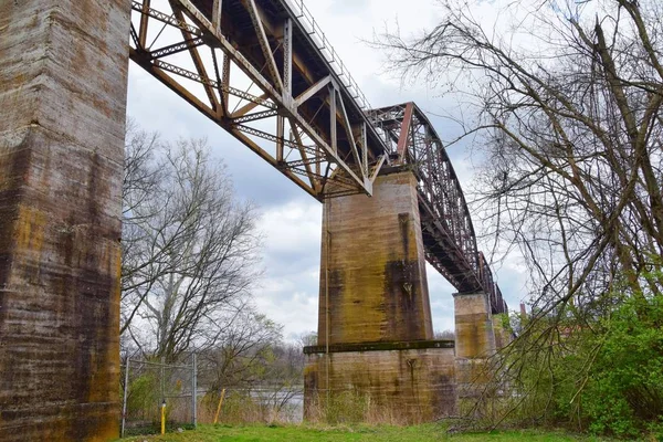 Train track railway bridge views along the Shelby Bottoms Greenway and Natural Area over Cumberland River frontage trails, Music City Nashville, Tennessee. United States.