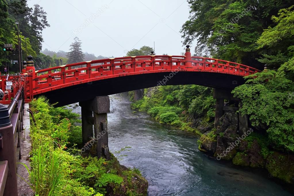 Shinkyo Bridge over the Daiwa River in Nikko outside of Tokyo, Japan in summer with cloud cover. Aisa.