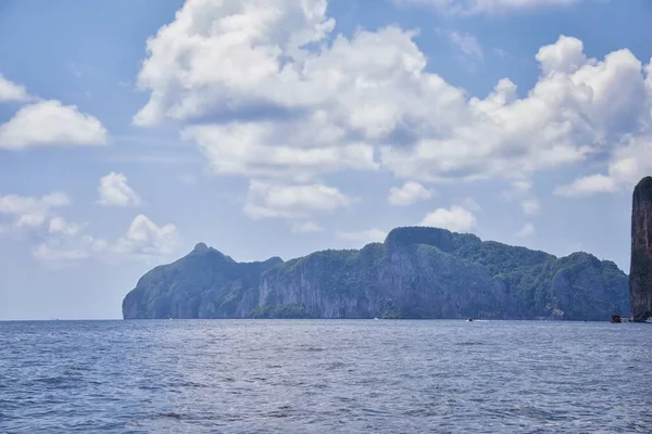 Island, Ocean views near Phuket Thailand with Blues, Turquoise and Greens oceans, mountains, boats, caves, trees resort island of phuket Thailand. Including Phi Phi, Ko Rang Yai, Ko Li Pe and other islands. Asia.