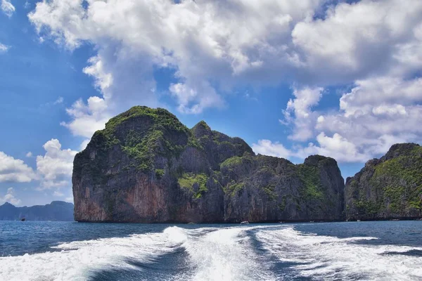 Island, Ocean views near Phuket Thailand with Blues, Turquoise and Greens oceans, mountains, boats, caves, trees resort island of phuket Thailand. Including Phi Phi, Ko Rang Yai, Ko Li Pe and other islands. Asia.