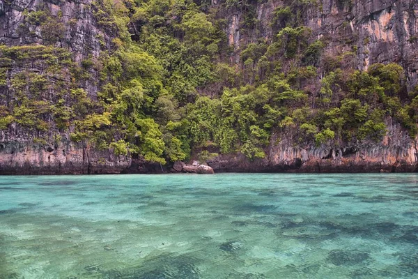 Island, Ocean views near Phuket Thailand with Blues, Turquoise and Greens oceans, mountains, boats, caves, trees resort island of phuket Thailand. Including Phi Phi, Ko Rang Yai, Ko Li Pe and other islands. Asia.