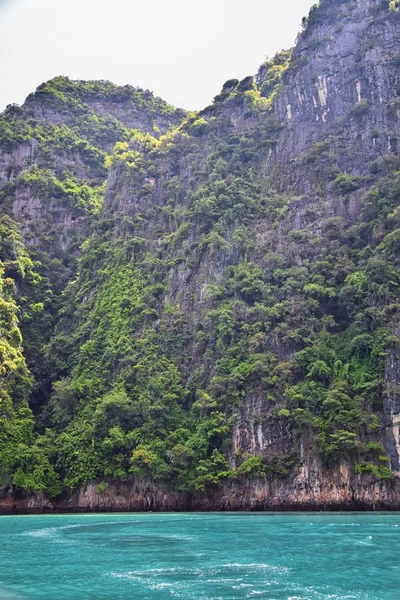 Island, Ocean views near Phuket Thailand with Blues, Turquoise and Greens oceans, mountains, boats, caves, trees resort island of phuket Thailand. Including Phi Phi, Ko Rang Yai, Ko Li Pe and other islands. Asia.