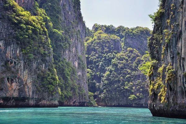 Island, Ocean views near Phuket Thailand with Blues, Turquoise and Greens oceans, mountains, boats, caves, trees resort island of phuket Thailand. Including Phi Phi, Ko Rang Yai, Ko Li Pe and other islands. Asia.