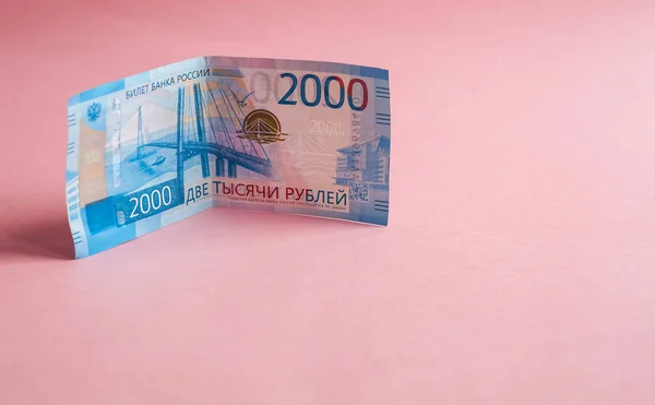 Russian banknotes in denominations of 2000 rubles on a pink background — Stock Photo, Image