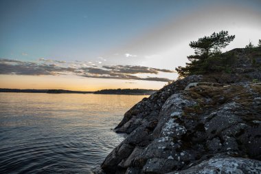 Göldeki adanın kayalık sahilinde. Ladoga Skerries, Karelia.