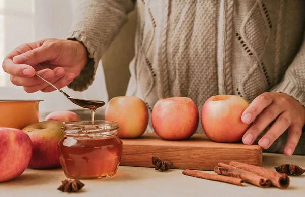 The girl prepares baked apples with honey. Healthy food.