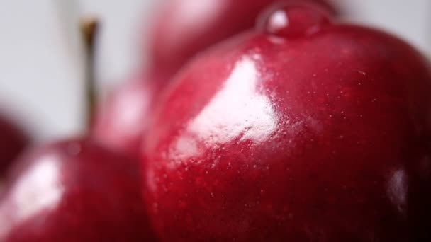Drop of water flows down a ripe cherry berry. Close-up macro shot, slow motion. — Stock Video