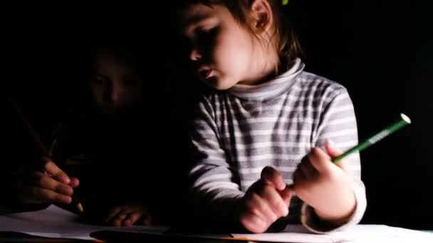Emotional baby girl draws a pencil with his older brother, close-up — Stock Video