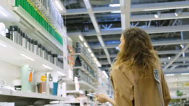 Güzel kadın bir alışveriş merkezi bir tablet bilgisayar pc, elektronik ortamda alışveriş listesi ile sıcak bir kupa seçer