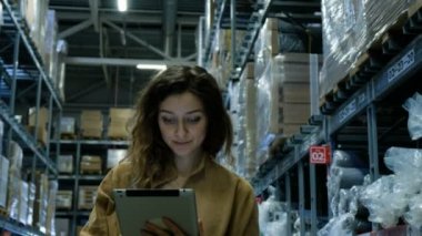 Tablet pc bilgisayar ticaret ambardaki bakarak güzel kadın