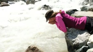 Kız bir dağ nehir el yardımıyla içecekler su turist