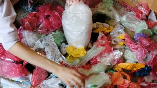 Separate collection of colored plastic bags, sorting for recycling female hand — Stock Video