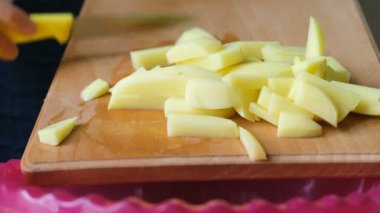 Kadın patates tahtadan bir derin kase yakın çekim kaydırır