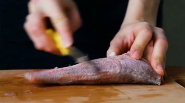 Kadın balık bir kesme tahtası üzerinde bir bıçak ile deniz ürünleri yakın çekim yemek temizler