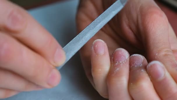 Woman makes herself a manicure - girl sawing nails close-up — Stock Video