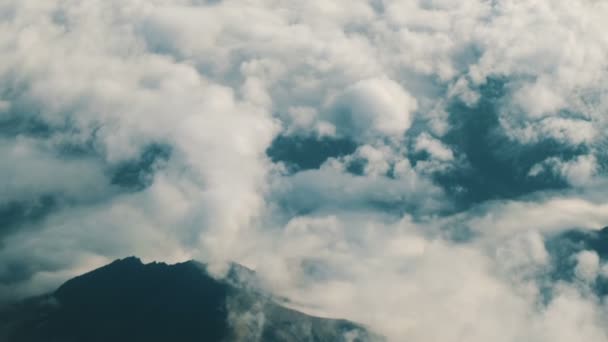Dağlar ve bulutlar üzerinde uçan bir uçağın penceresinden görüntülemek. — Stok video