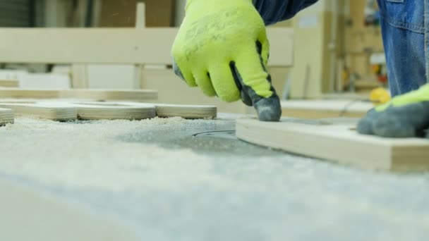 Arbetaren tar bort radien fasfräs i en möbelfabrik. Tillverkning av trämöbler — Stockvideo