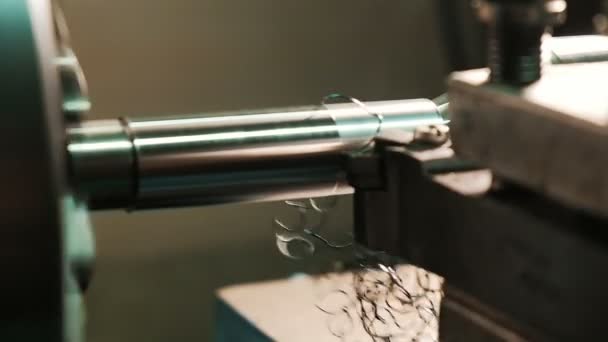 Turning lathe in action. Cutter removes metal shavings from the steel billet in slow motion, close-up. Metal processing on a lathe — Stock Video