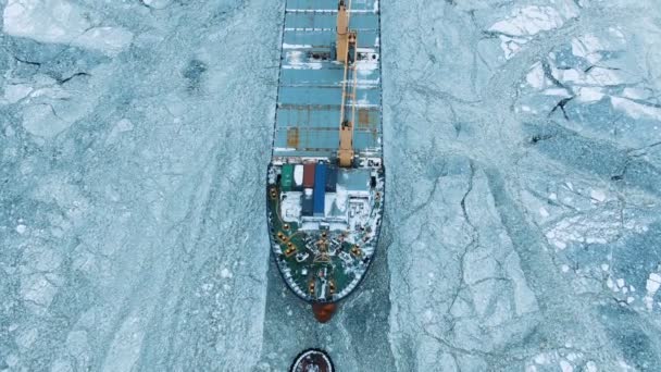 Aerial view. The big ship sails through the sea ice in the winter, close-up — Stock Video