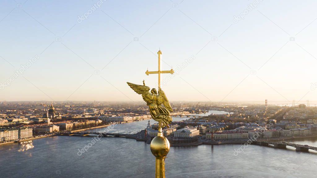 Angel figure and cross on the spire of Peter and Paul Cathedral at sunset, Petersburg aerial view