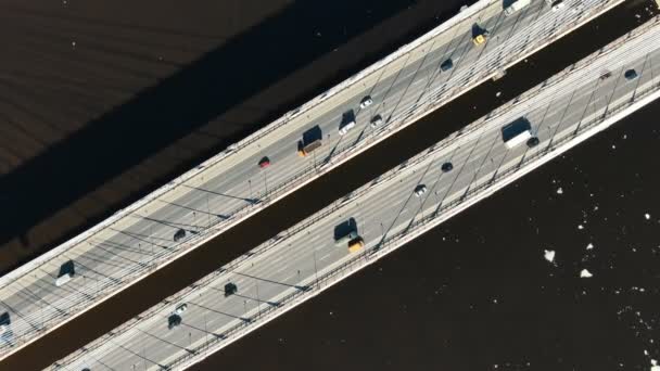 Cars driving on a modern cable-stayed bridge, aerial view vertically down. — Stock Video