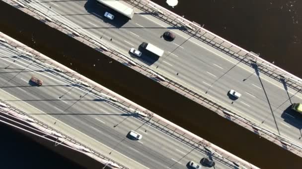 Aerial shooting over the cable-stayed bridge, zoom out from the cars over the river — Stock Video