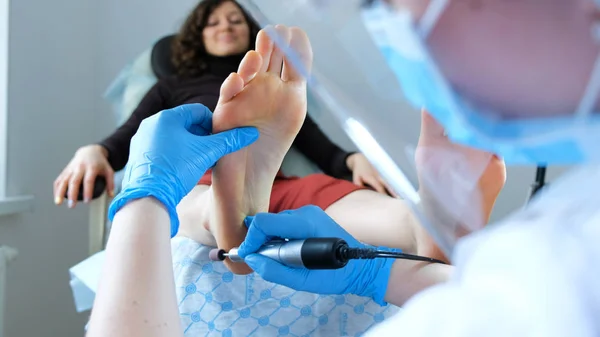Medical hardware pedicure - pedicure master makes peeling on clients feet