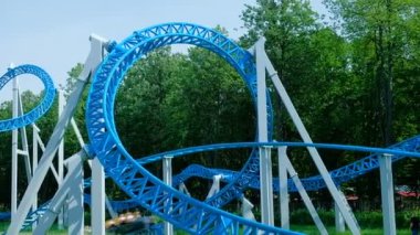 insanlar mavi roller coaster üzerinde baş aşağı daire binmek