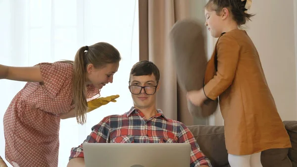 Ο άνθρωπος προσπαθεί να εργαστεί στο διαδίκτυο, ενώ η κόρη χτυπά και η σύζυγος μιλάει — Φωτογραφία Αρχείου