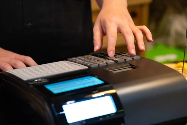 cash register installed on counter for accepting order from customer.sales man entering amount on electronic cash register in coffee shop and retail store.restaurant cashier typing on cash register.