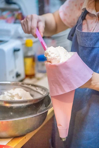 whipped cream cooking process.woman mixing Fresh cream for makin