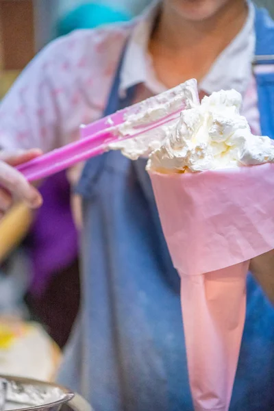 whipped cream cooking process.woman mixing Fresh cream for makin