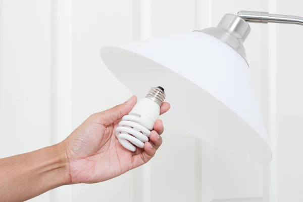 Closeup Hand Changing Electric Light Bulb — Stock Photo, Image
