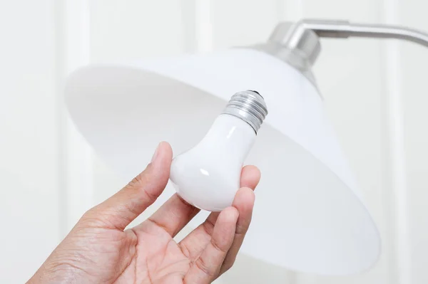 Closeup Hand Changing Electric Light Bulb — Stock Photo, Image