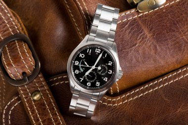 Closeup military or field style wristwatch, luxury automatic wristwatch for men clipart