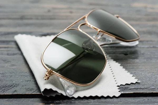 men accessories, closeup sunglasses with gold frame.