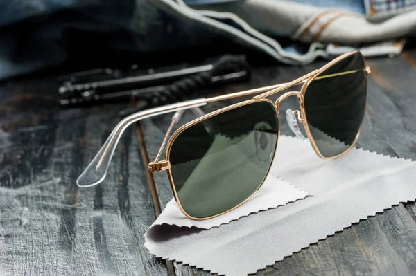 men accessories, closeup sunglasses with gold frame.