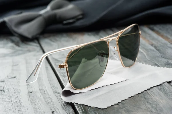 men accessories, closeup sunglasses with gold frame.