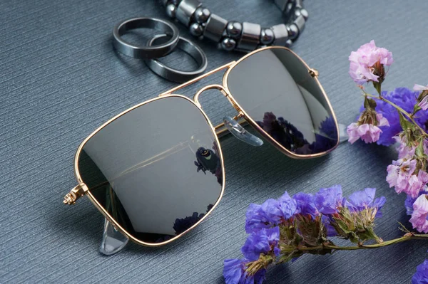 accessories, closeup sunglasses with gold frame.