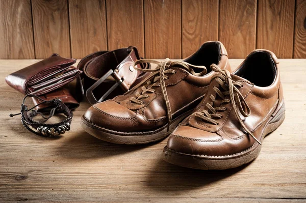old brown leather shoes for men on wood background