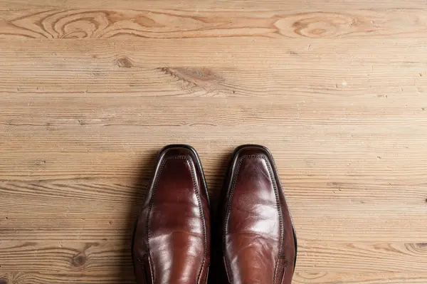 brown leather shoes for men, luxury leather shoes on wooden background
