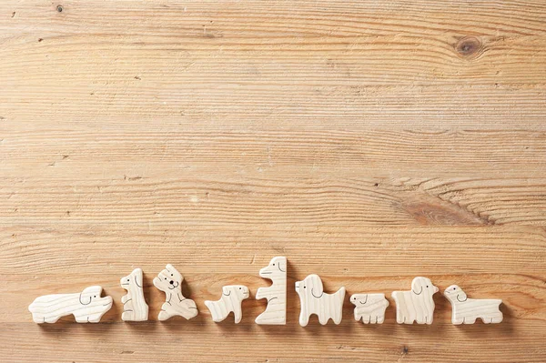 toys background, cute wooden toy animal on wood board, tiny toys and shallow depth of field