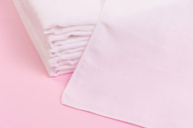 Pembe arka planda beyaz ve yumuşak bebek bezleri