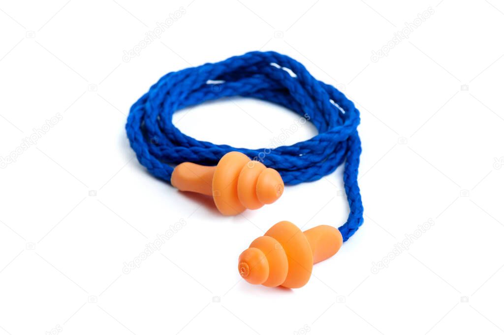 Orange reusable ear plugs over white background, personal safety equipment
