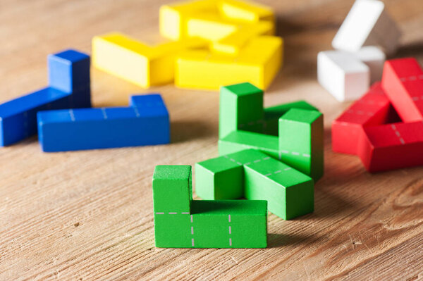 colorful wooden puzzle blocks toy, wooden construction blocks with geometric shapes.